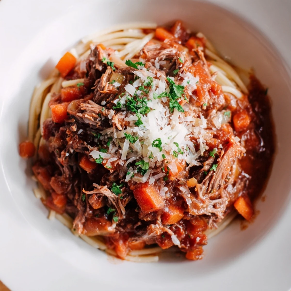 A steaming bowl of Slow Cooker Beef Ragu served over creamy polenta, garnished with fresh parsley.