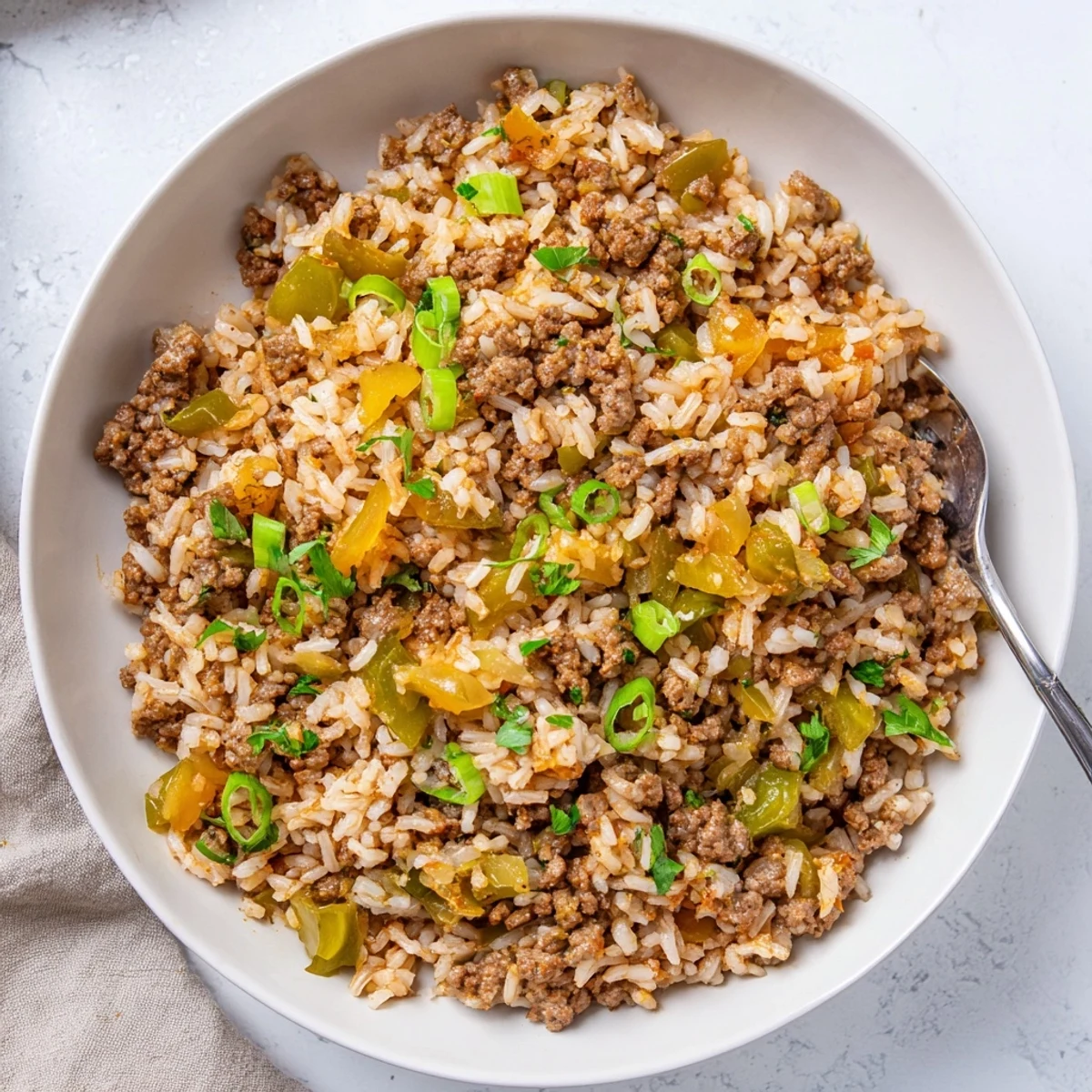 Savory Mardi Gras Dirty Rice with Beef, featuring tender ground beef, bell peppers, and onions in a spicy, aromatic Creole sauce.