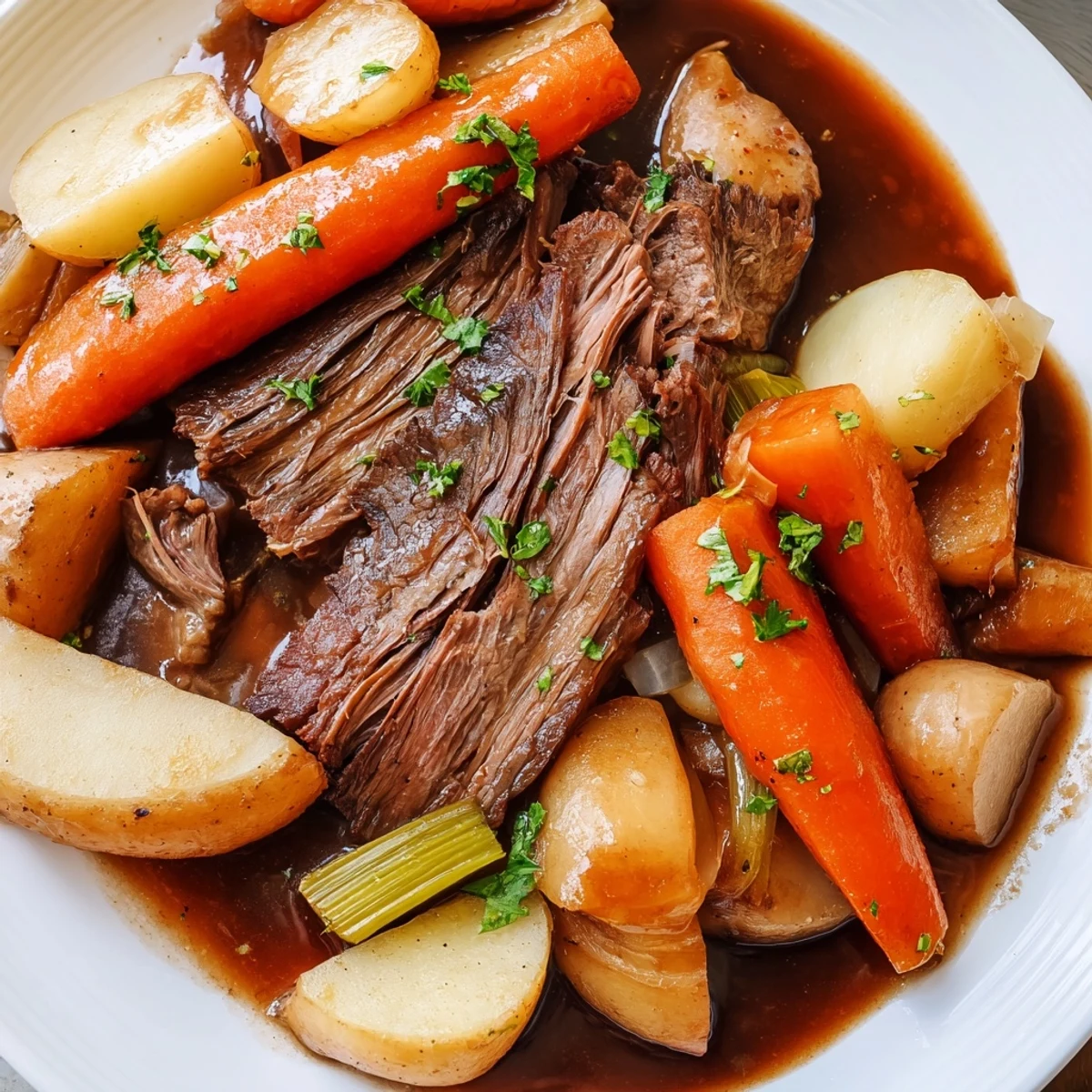 Golden-brown Irish Beef Pot Roast with Root Vegetables served from a Dutch oven, garnished with fresh parsley and savory broth.