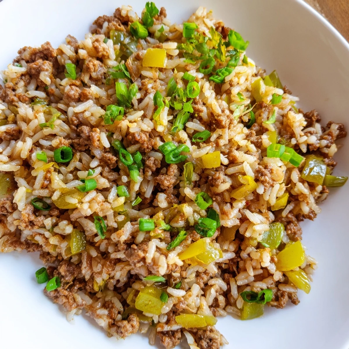 A close-up of Cajun Dirty Rice with Ground Beef and Herbs on a plate, showcasing seasoned beef, peppers, and fluffy rice.