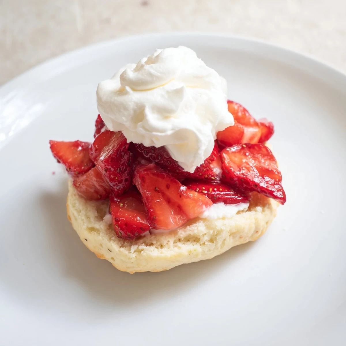 Sliced ripe strawberries and billowy whipped cream topping homemade biscuits for a delicious Strawberry Shortcake with Homemade Biscuits.