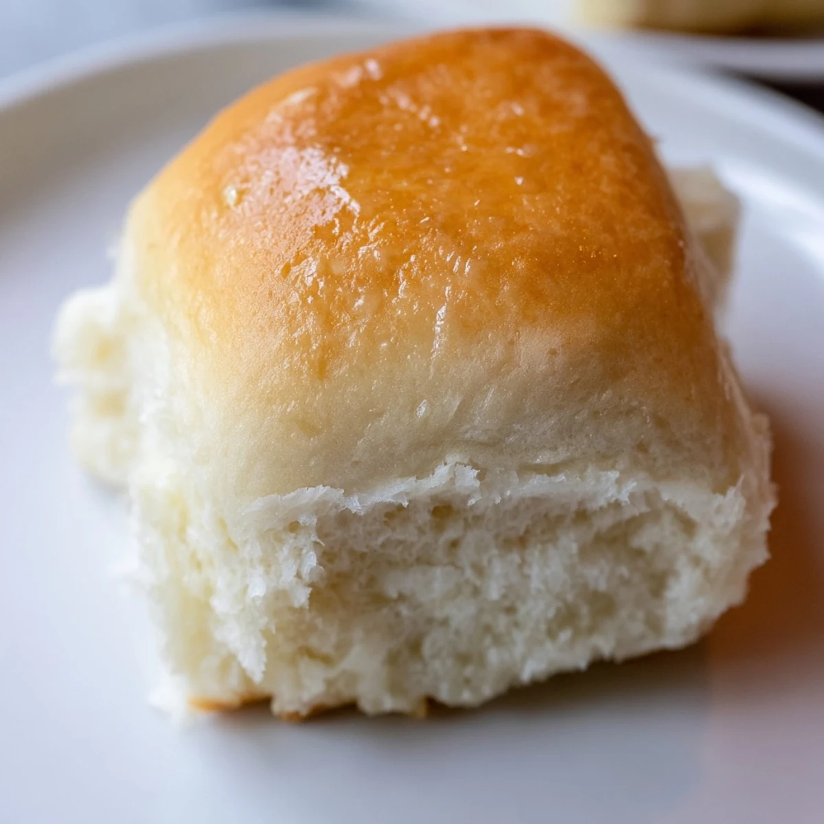 Golden-brown Best Vegan Dinner rolls resting on a wire rack, ready to serve warm with spreads.