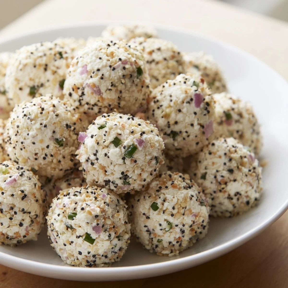 Creamy Everything Bagel Cottage Cheese Bites on a platter with fresh chives for a protein-packed snack.