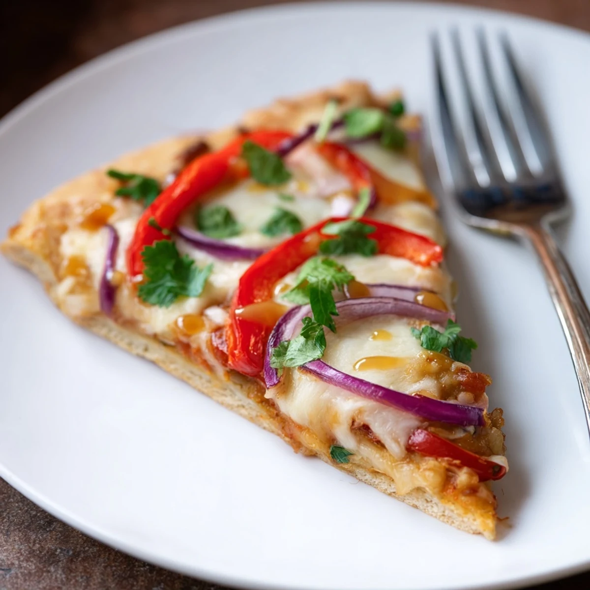 Fresh cilantro and jalapeño slices top this Sweet Heat Honey Garlic Flatbread Pizza on a rustic board.
