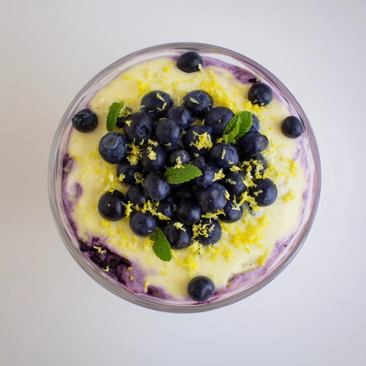 Delicious Lemon Blueberry Mousse in dessert glasses garnished with lemon zest and blueberries, perfect for a light summer treat.
