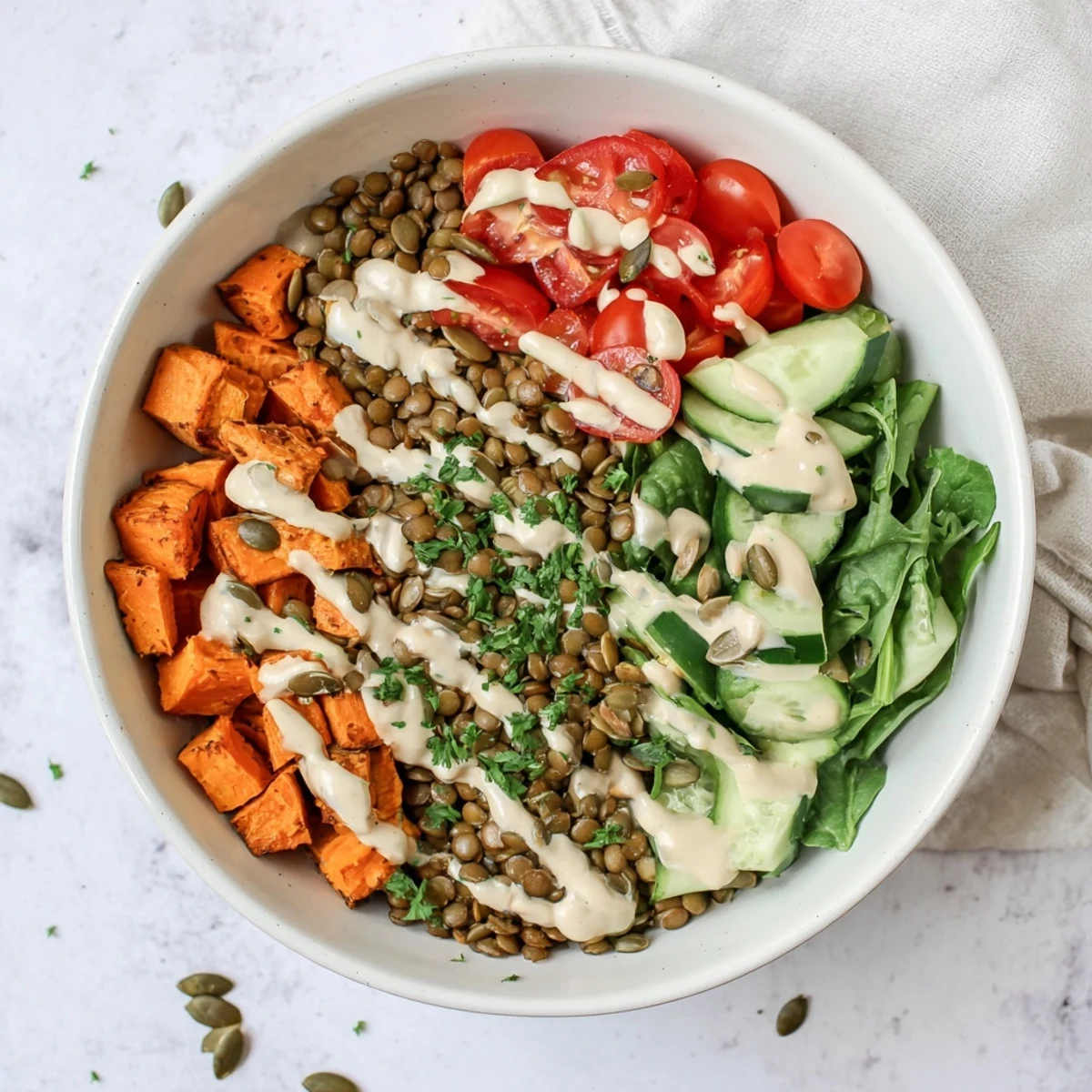 A vibrant bowl of the Healthy Lunch Sweet Potato Lentil Bowl, featuring roasted orange cubes, tender lentils, and fresh spinach.