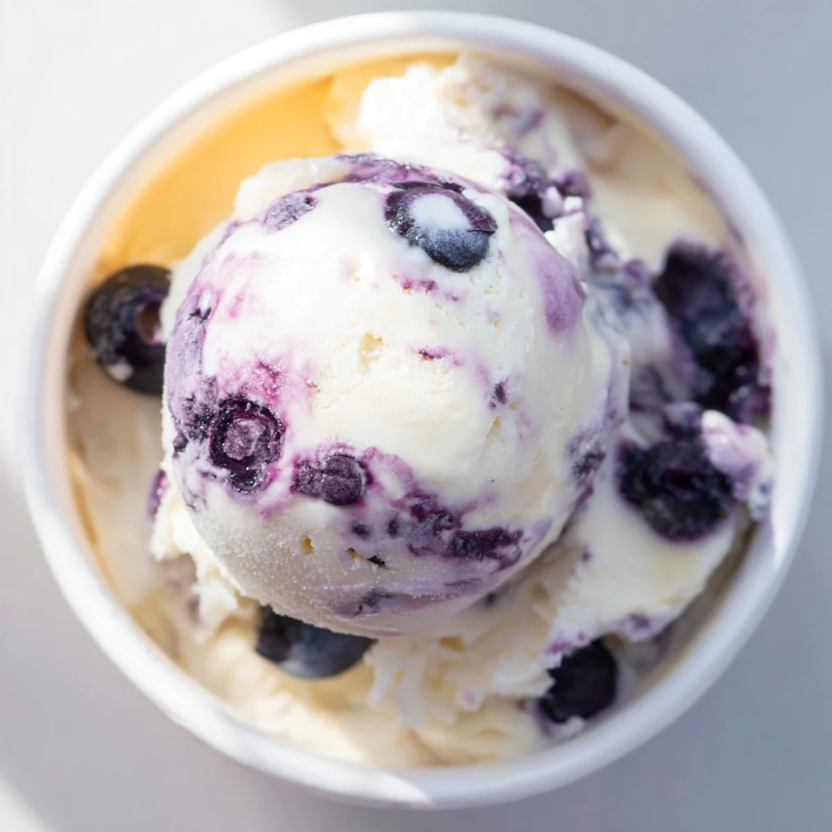 Blueberry Cottage Cheese Ice Cream served in cones, perfect for a summer dessert with sweet berry bursts.