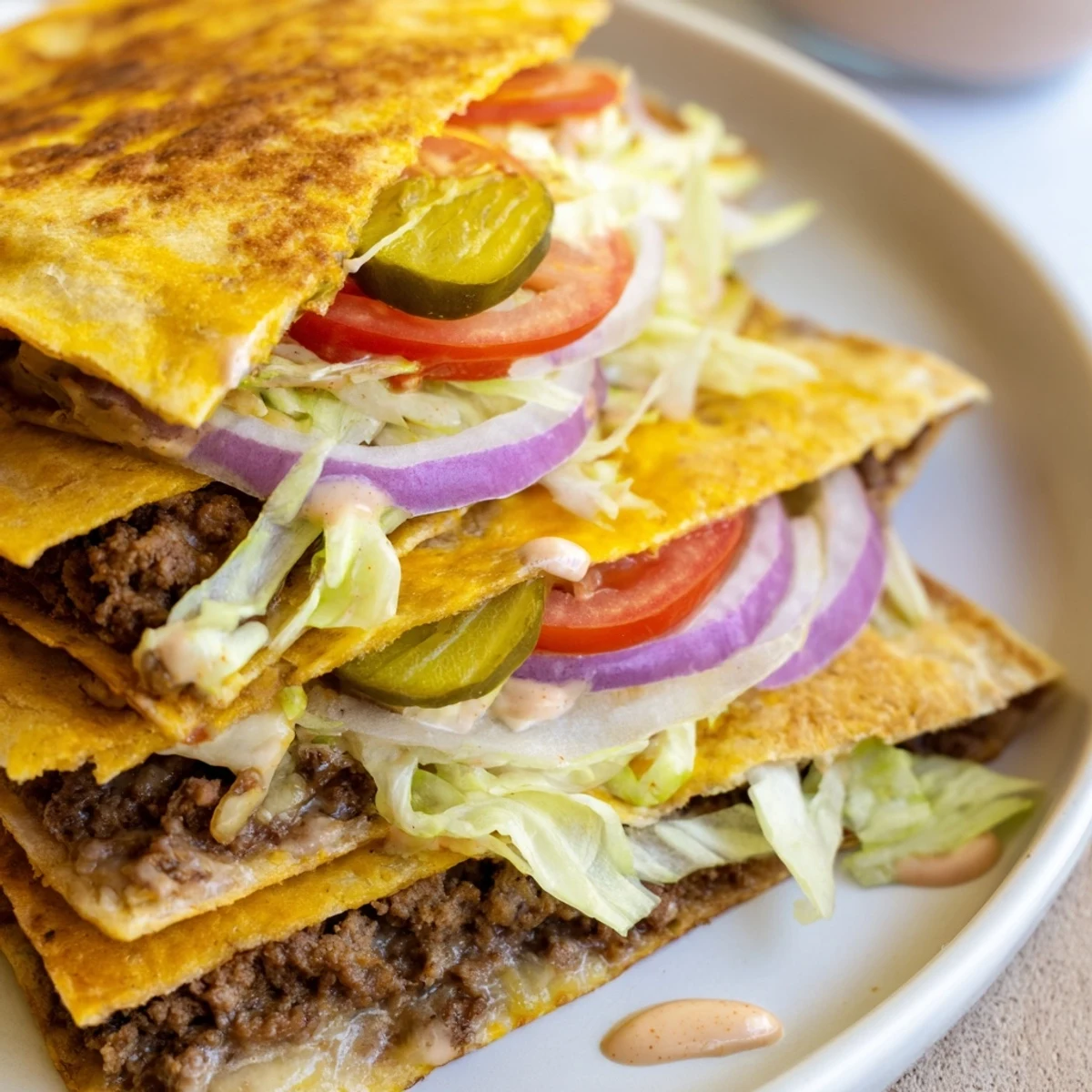 Savory American-Mexican fusion quesadilla with grilled ground beef, fresh vegetables, and creamy burger sauce