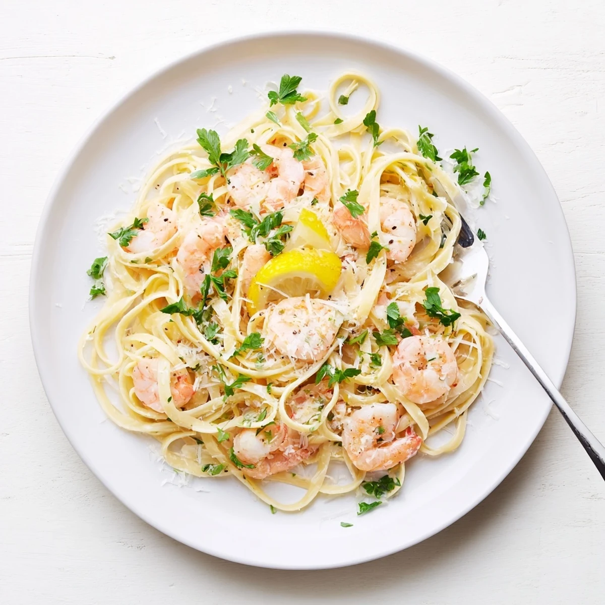 Succulent shrimp tossed in garlic cream sauce over linguine with lemon wedges