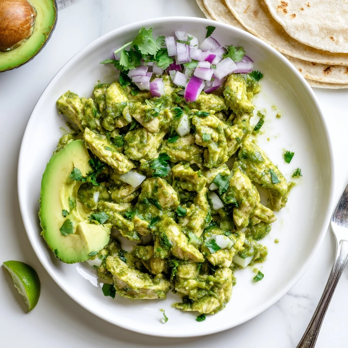 Tender chicken breasts coated in zesty salsa verde, ready for warm corn tortillas and tacos.