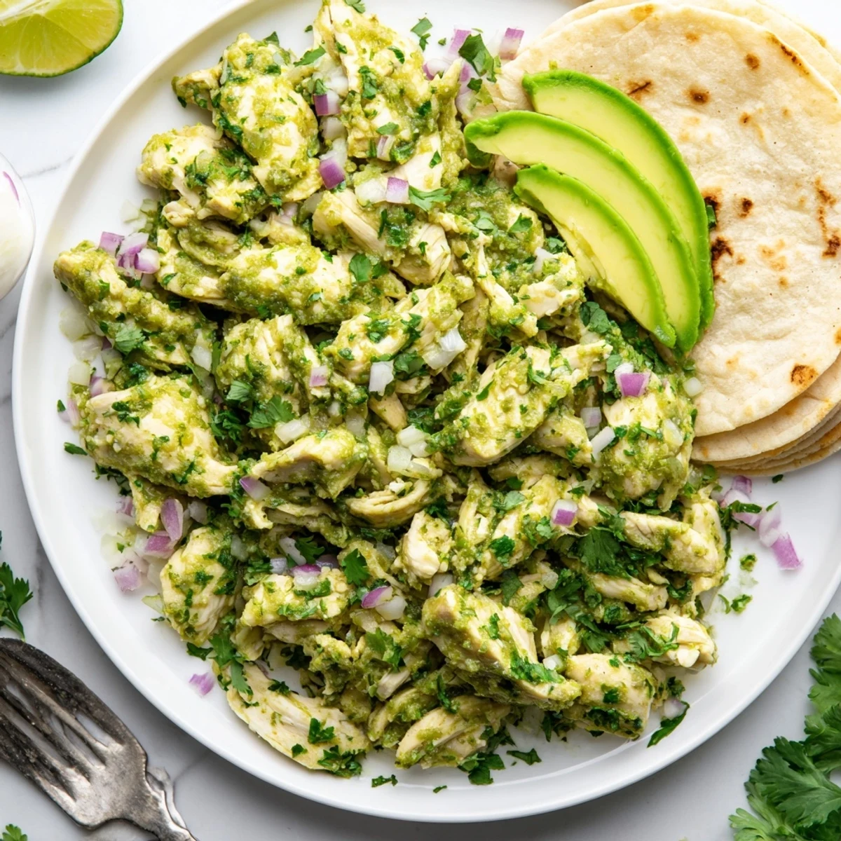 Golden pan-seared chicken in tangy green tomatillo sauce with lime, served inside soft tortillas.