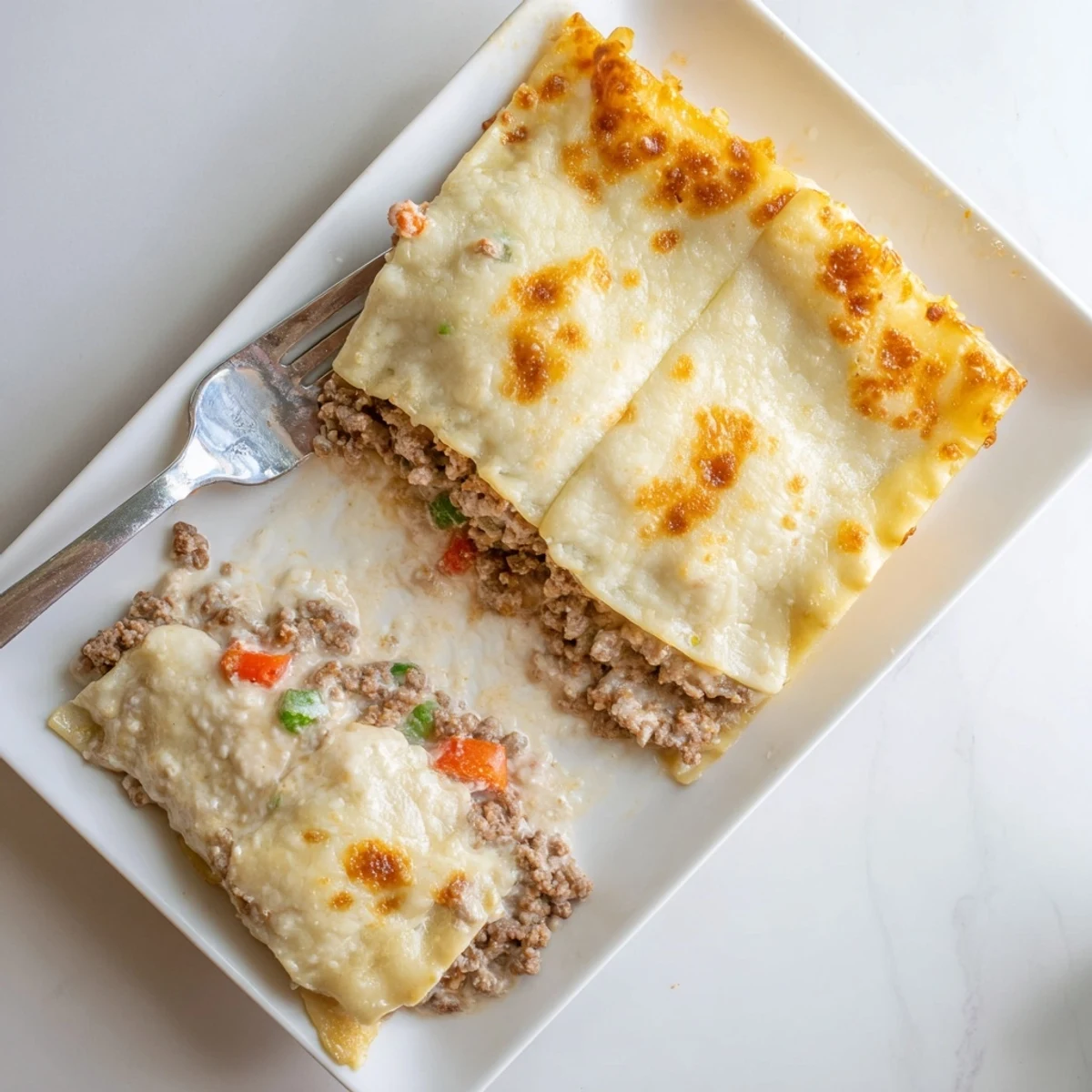 Golden brown classic beef lasagne with bubbling mozzarella and rich tomato meat sauce layered between tender pasta sheets