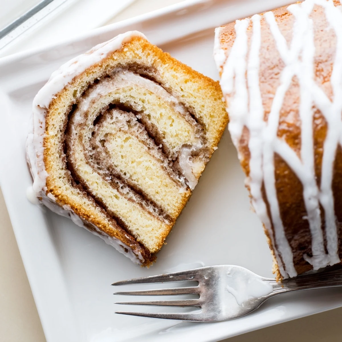 Buttery breakfast cake with marbled cinnamon sugar ribbons topped with silky sweet glaze