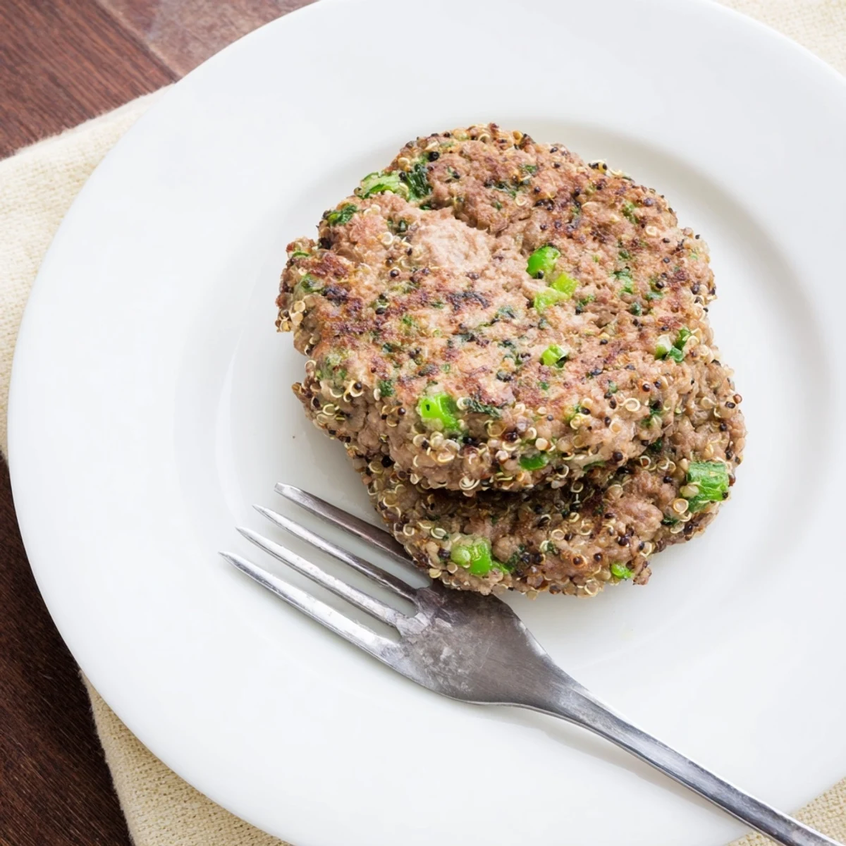 Juicy homemade turkey broccoli quinoa burgers with visible green vegetables and tender texture