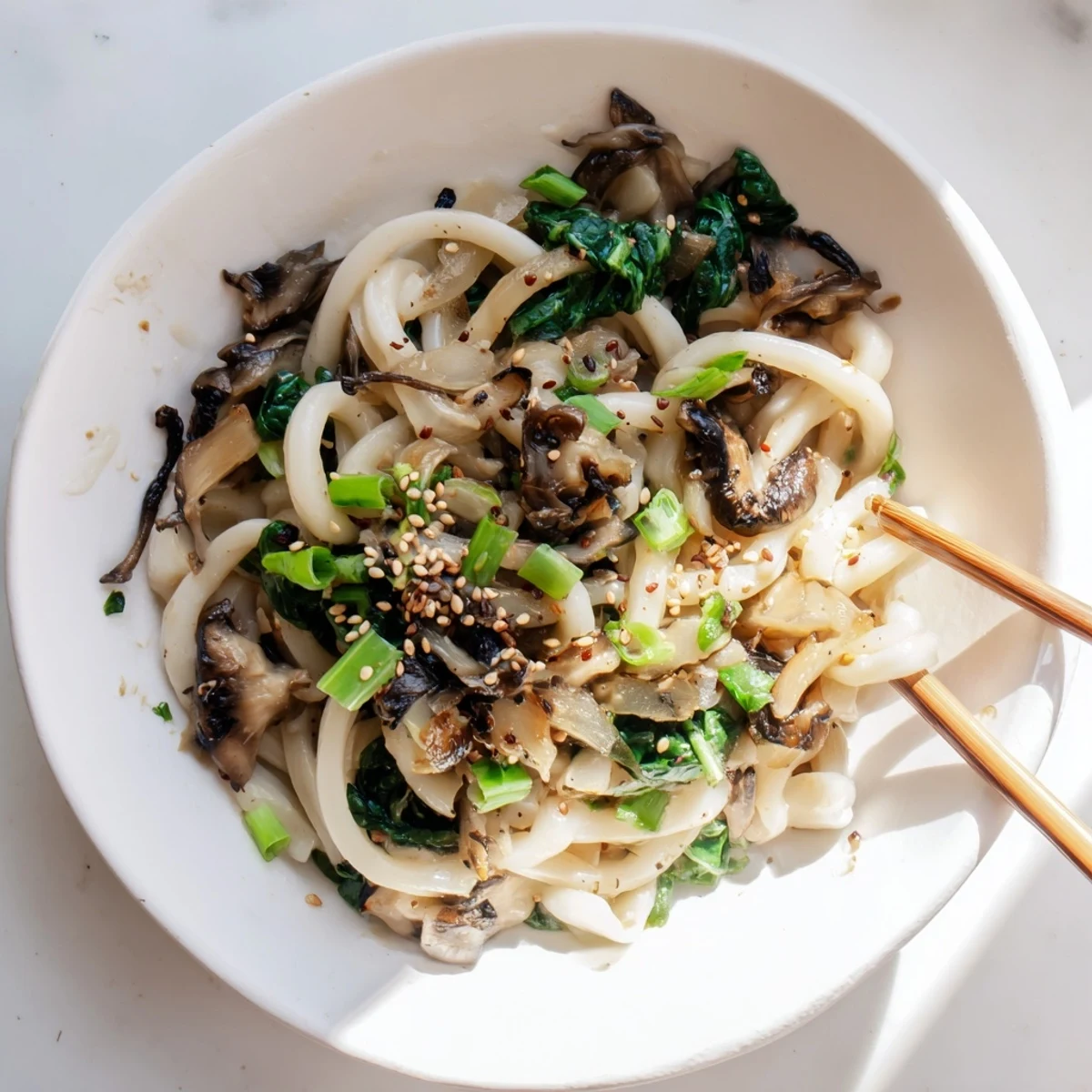 Japanese-inspired creamy miso udon bowl featuring tender noodles and vegetables in golden umami sauce
