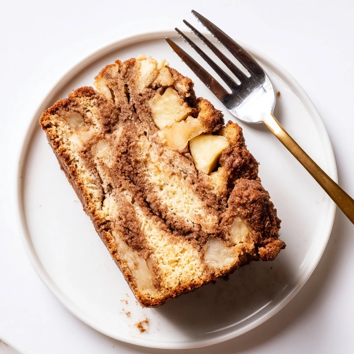 Freshly baked cinnamon apple bread cooling on wire rack with golden brown crust and cinnamon sugar topping