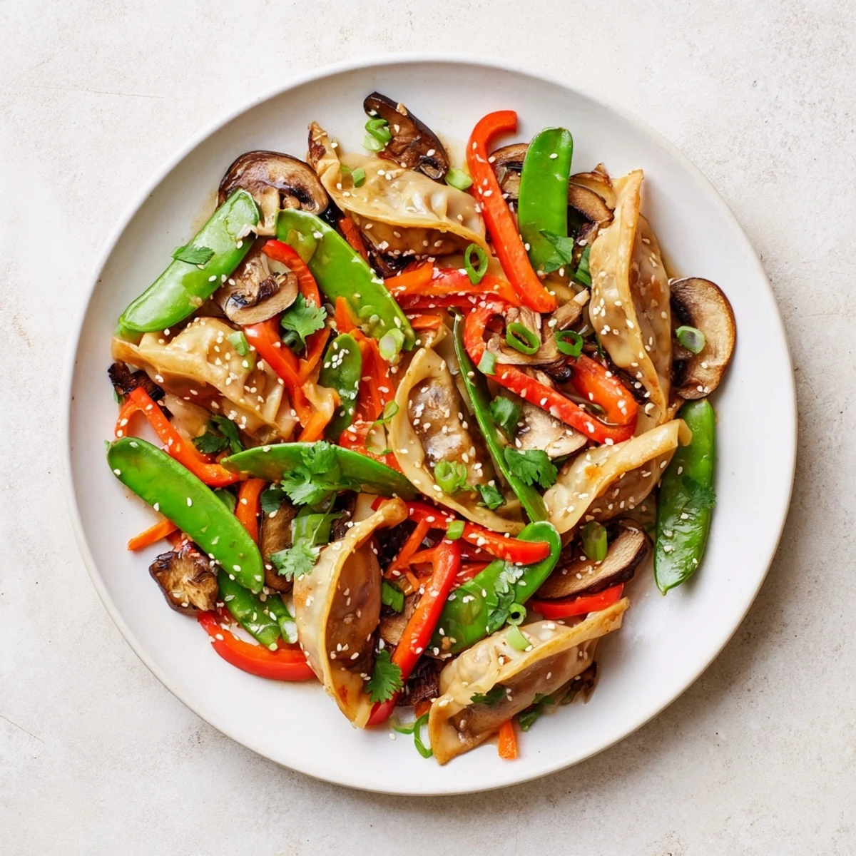 Crispy golden potstickers tossed with colorful vegetables in a savory Asian stir fry sauce