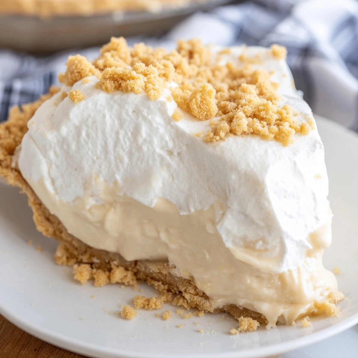 Creamy Amish Peanut Butter Dream Pie topped with fluffy whipped cream and crumbly peanut butter garnish