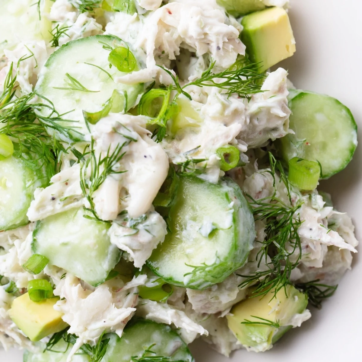 Cucumber salad with crab meat nestled in creamy dressing topped with fresh dill