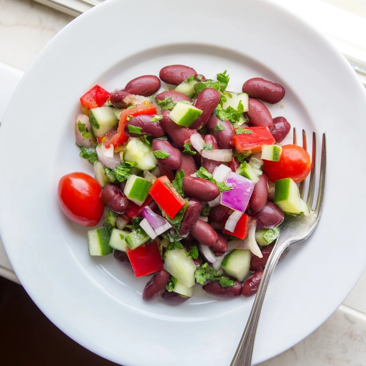 Colorful kidney bean salad with crisp vegetables and tangy vinaigrette in a serving bowl