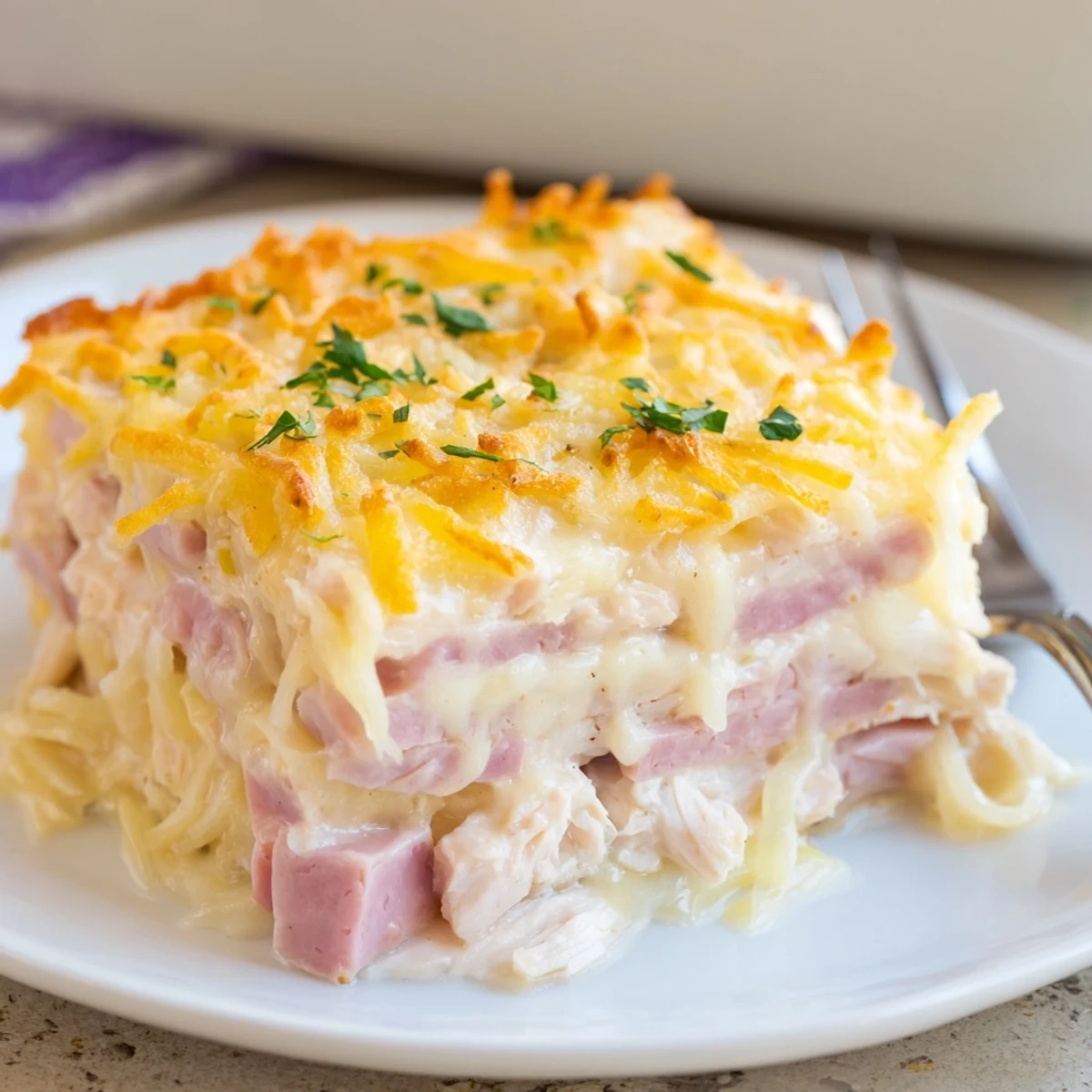 Creamy Dijon-sauced Chicken Cordon Bleu Casserole rests steaming, ready to serve