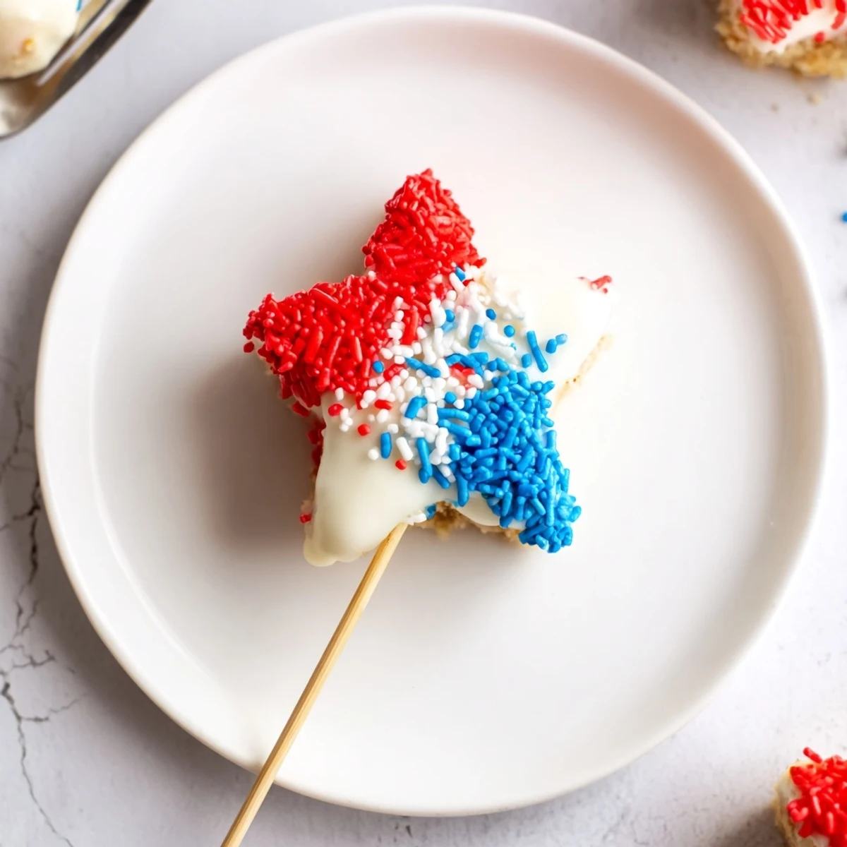 Chilled Fourth Of July Star Cheesecake Pops nestled in parchment, ready to serve