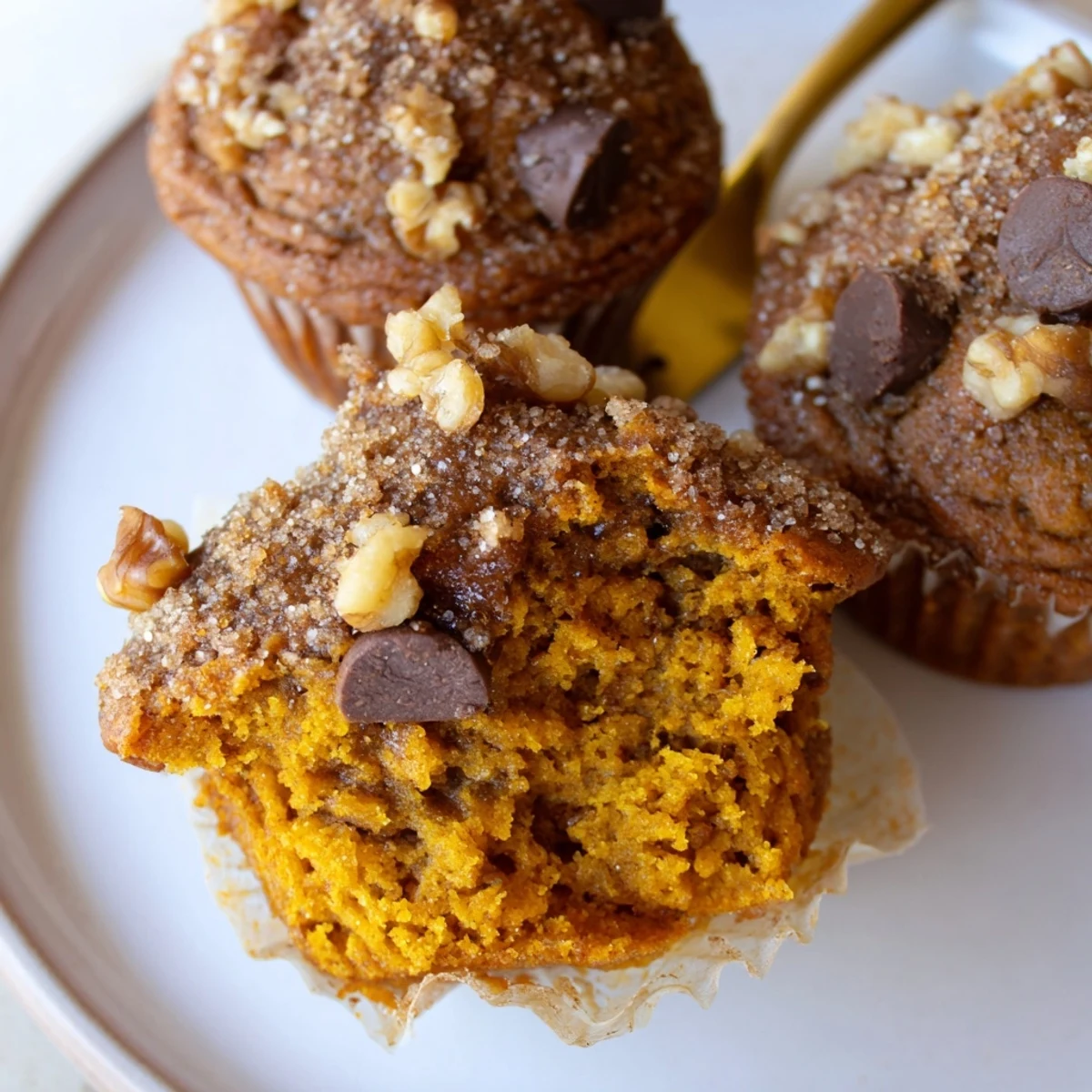 Moist Pumpkin Banana Muffins with chopped pecans, ready for autumn breakfasts