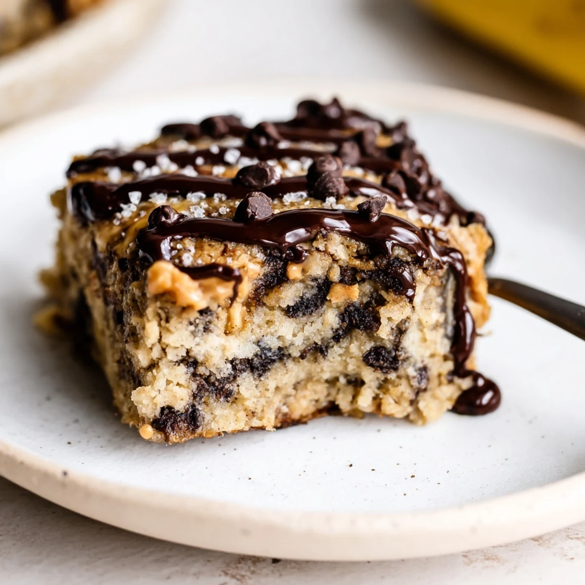 Thick Flourless Peanut Butter Banana square topped with melted chocolate, flaky salt