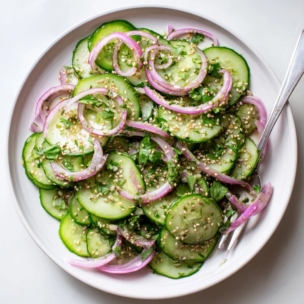 Fresh honey lime cucumber salad with crisp cucumber slices and red onion in a tangy citrus dressing