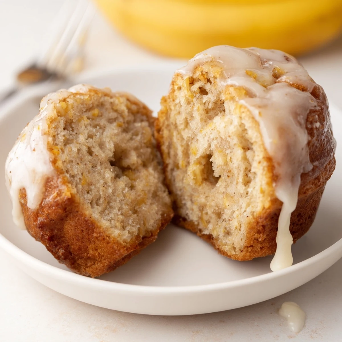Warm Banana Donuts glistening with vanilla glaze, steaming beside a coffee