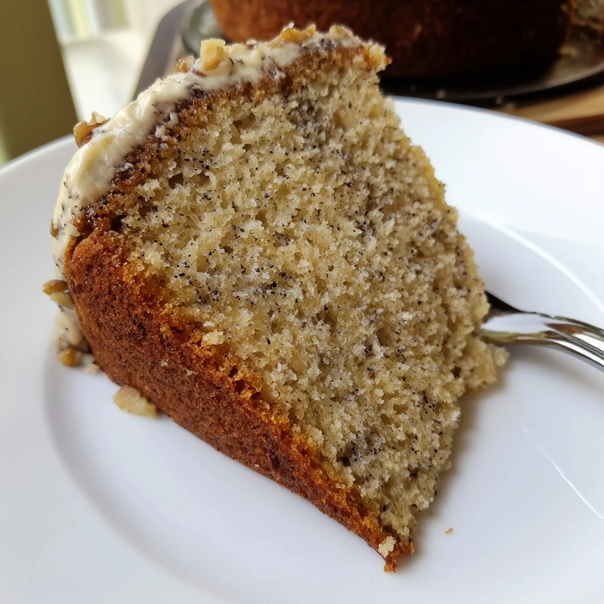 Moist Banana Cake sliced on a cooling rack, warm banana aroma.