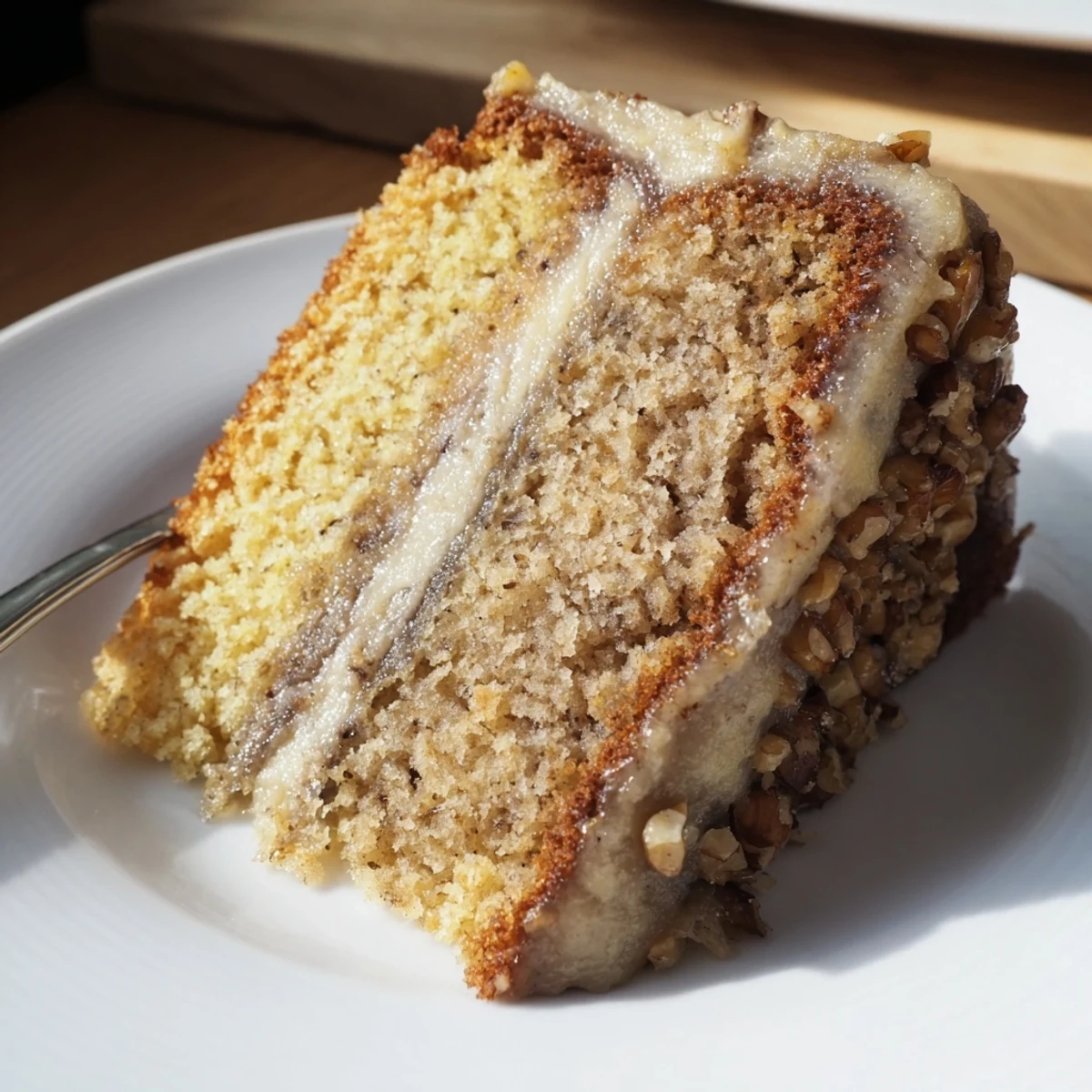 Homestyle Moist Banana Cake on a plate, fork ready for serving.