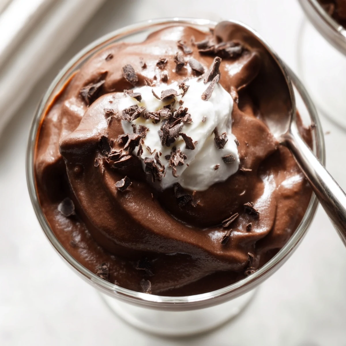Silky chocolate mousse with a glossy finish garnished with dark chocolate curls