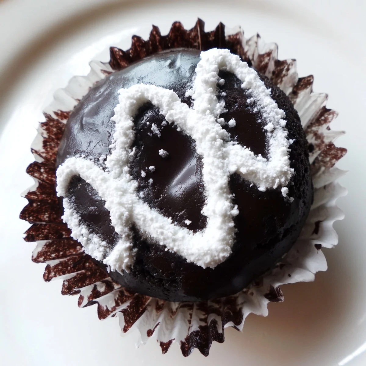 Homemade Hostess Cupcakes with glossy chocolate ganache and signature white icing swirls