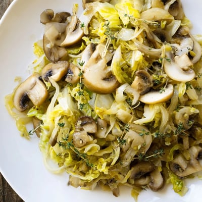 Fresh chopped parsley garnishes this vibrant Vegetarian Cabbage Mushroom Sauté ready to be served.