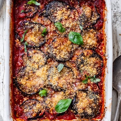 A bubbling, golden baked Charred Aubergine Parmigiana served warm, ready to scoop onto plates for dinner.