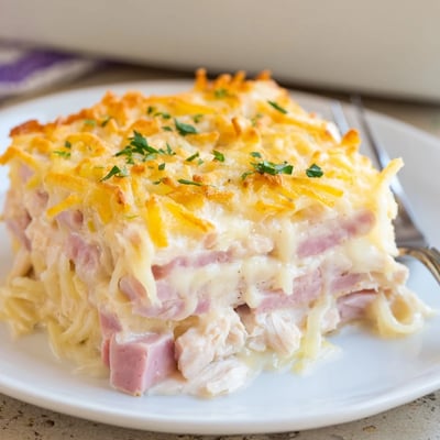 Creamy Dijon-sauced Chicken Cordon Bleu Casserole rests steaming, ready to serve